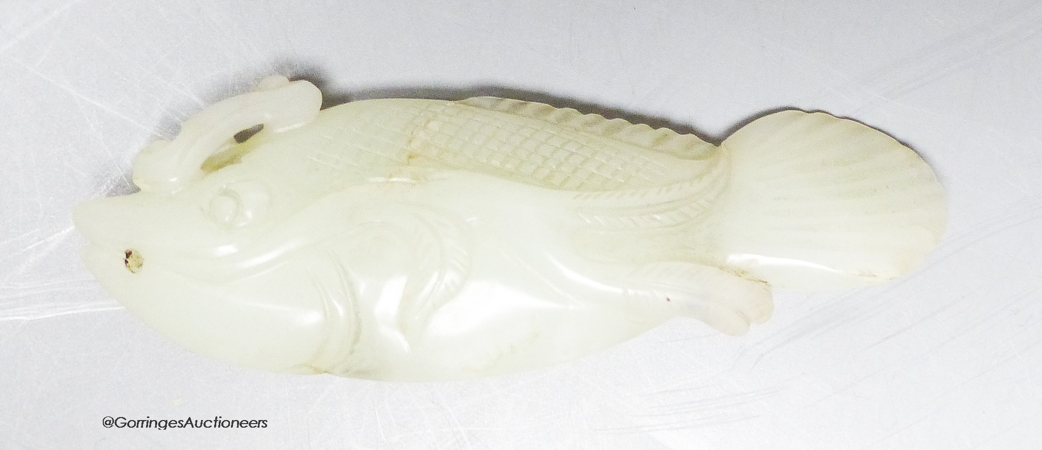 A Chinese pale celadon jade carving of a fish, 8.7 cm